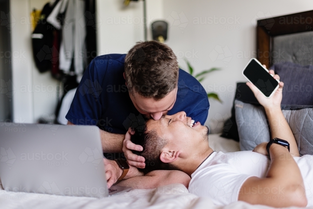 Cute moment - Man kissing boyfriend on the forehead - Australian Stock Image