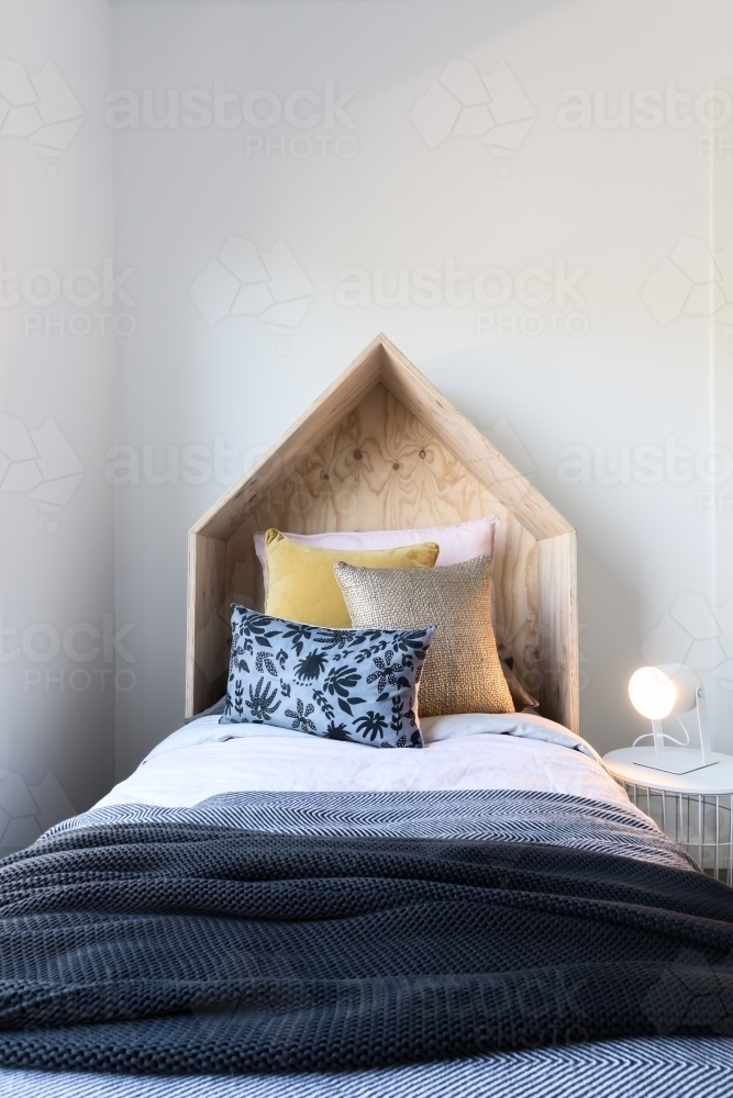 Cute wooden tent style wooden bedhead in a styled children's bedroom - Australian Stock Image