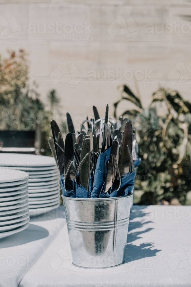 Cutlery and plates in the sunshine. - Australian Stock Image