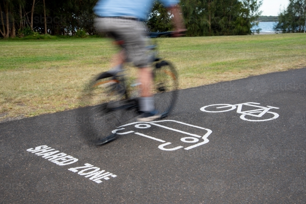 Cycle Path Dim Image of Cycle path shared zone with bike rider - Austockphoto