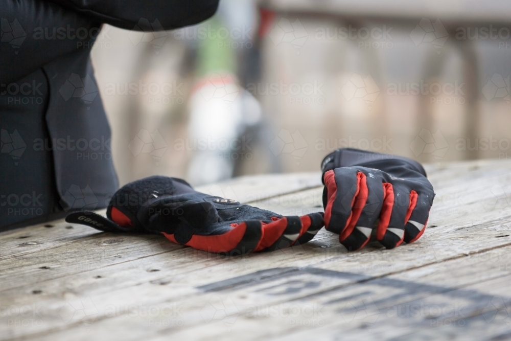 Cycling gloves on a table at a cafe - Australian Stock Image