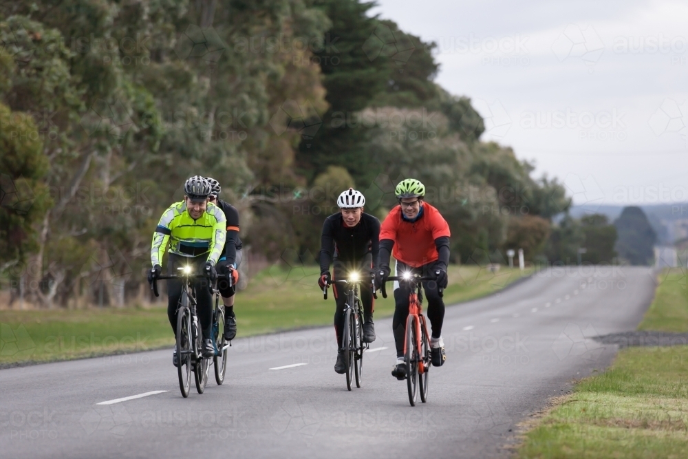 Cyclist riding in the middle of the country road - Australian Stock Image