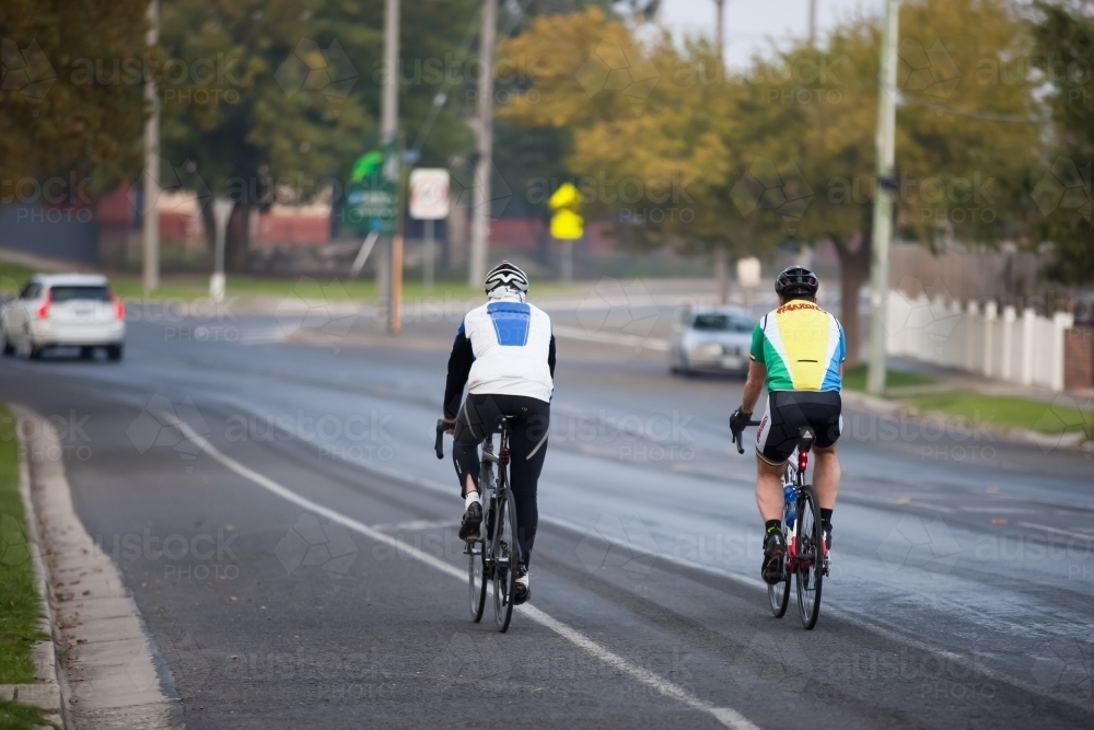 cyclists riding on a bike lane in a city - Australian Stock Image