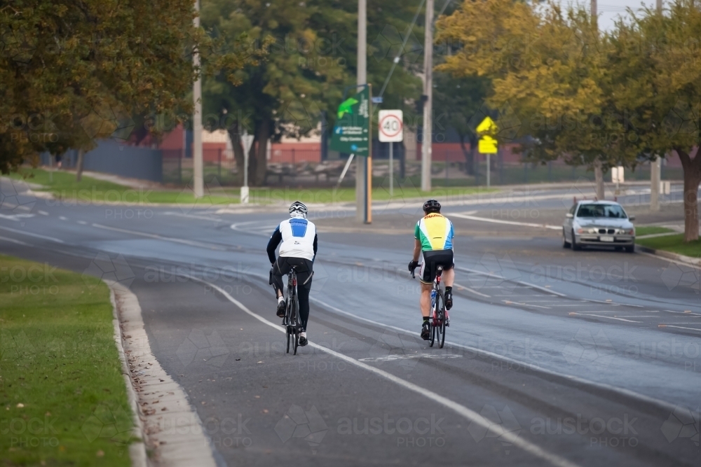 cyclists riding on a bike path in a city - Australian Stock Image