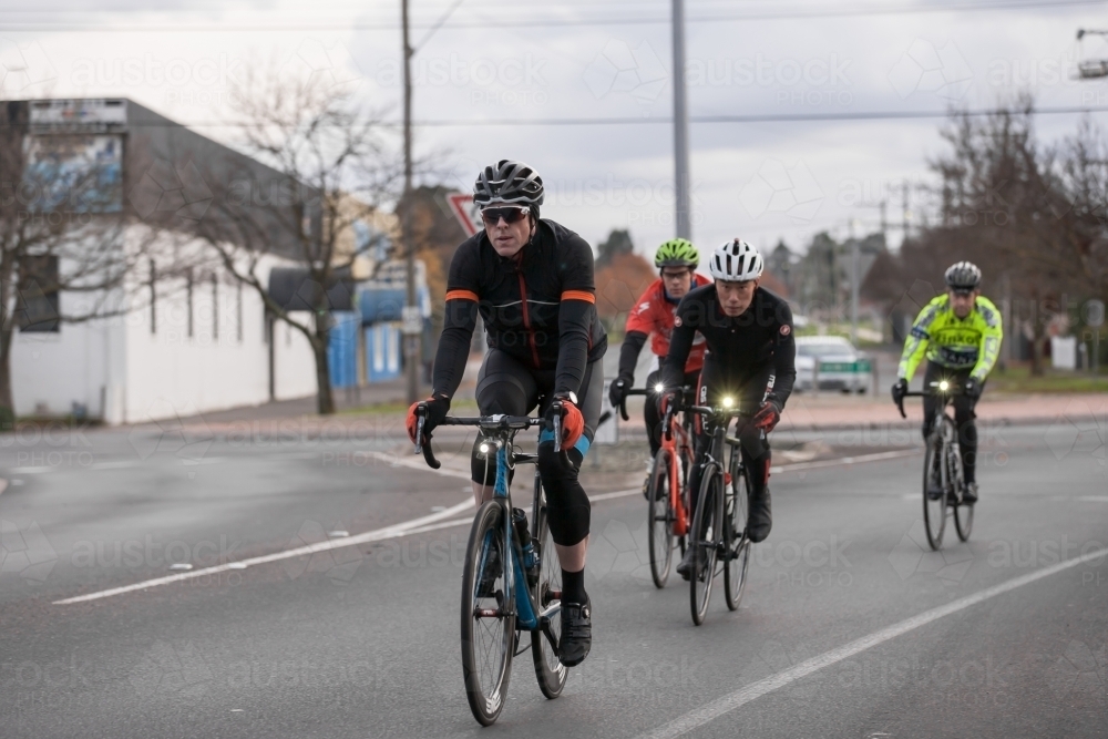 Cyclists riding through city streets - Australian Stock Image