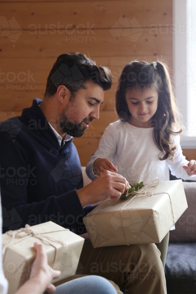 Dad and daughter opening present - Australian Stock Image