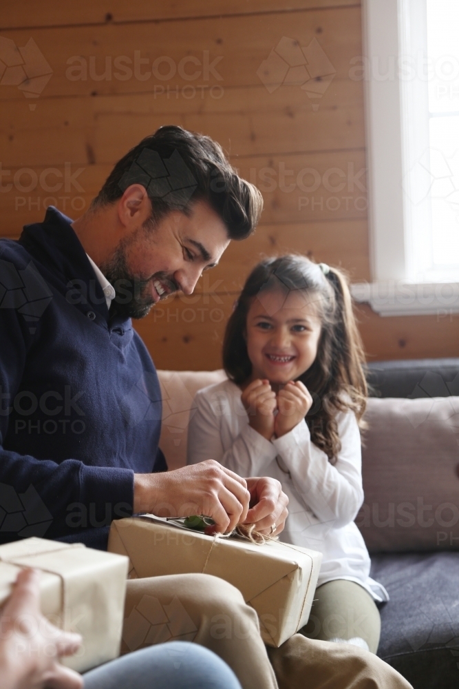 Dad and daughter opening present - Australian Stock Image