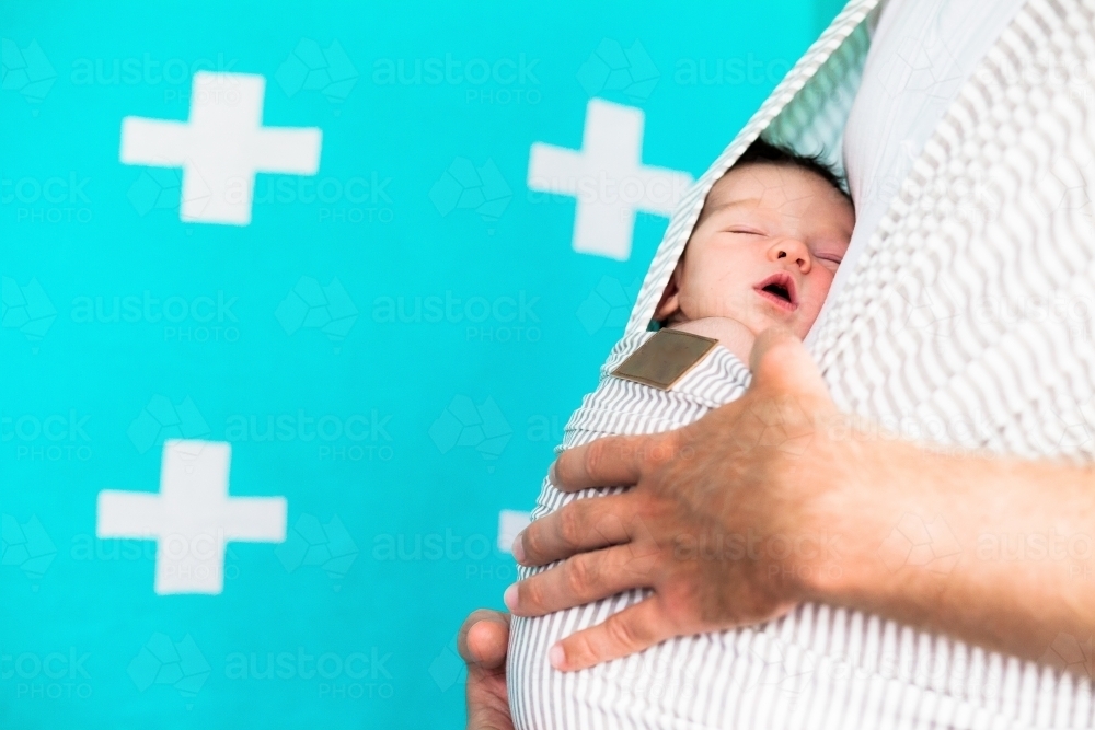 Dad carrying baby - Australian Stock Image