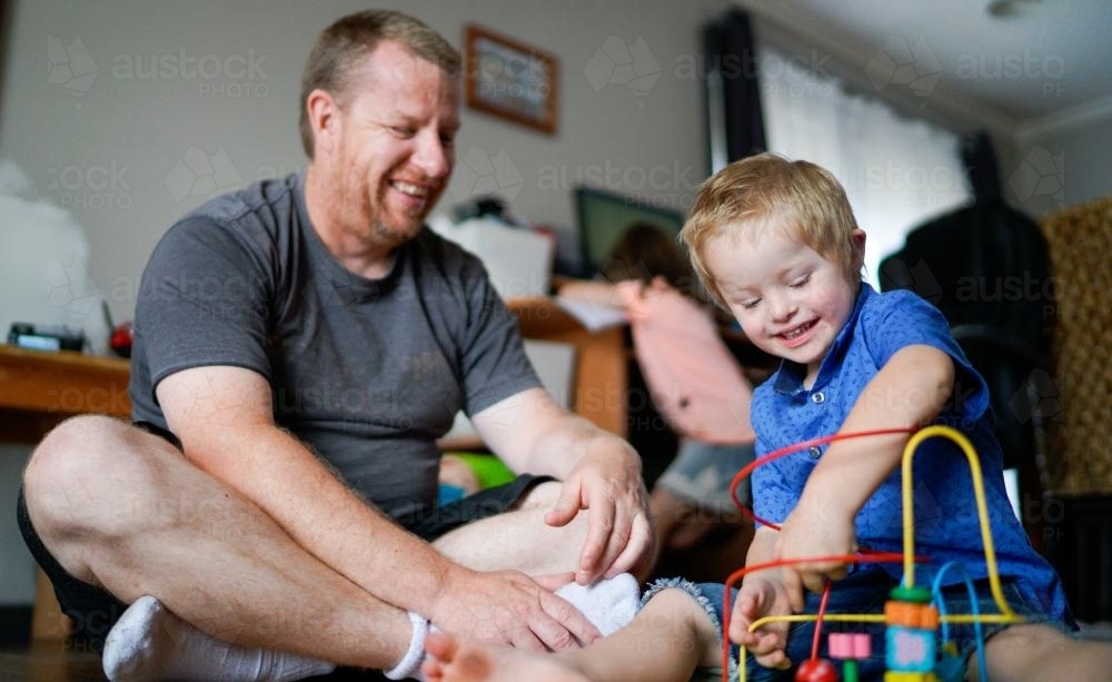 Dad with his Boy Playing on Floor - Australian Stock Image