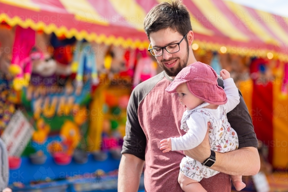 Dad with young baby at sideshow alley of local country show - Australian Stock Image