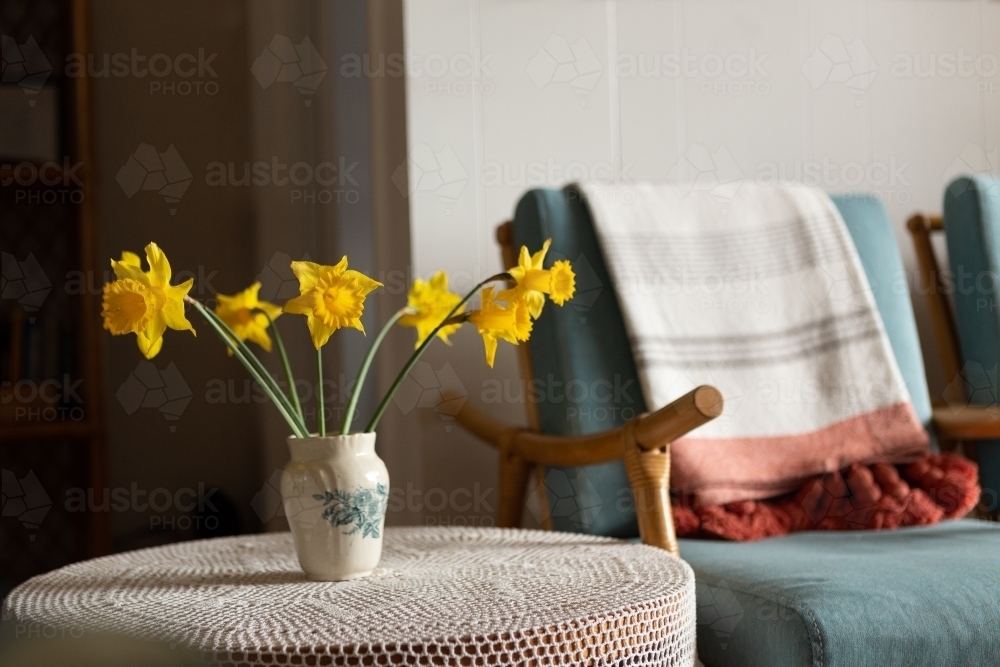 Daffodils in vase on lace - Australian Stock Image
