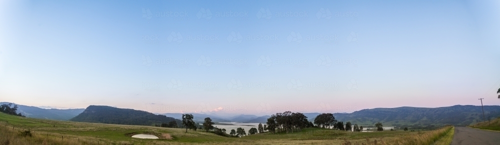 Dam on hill beside Lake St Clair at dusk with clear sky - Australian Stock Image