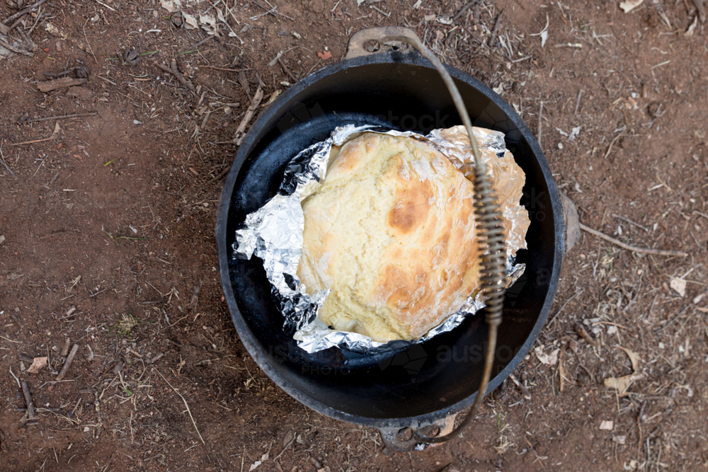 Damper in a camp oven - Australian Stock Image