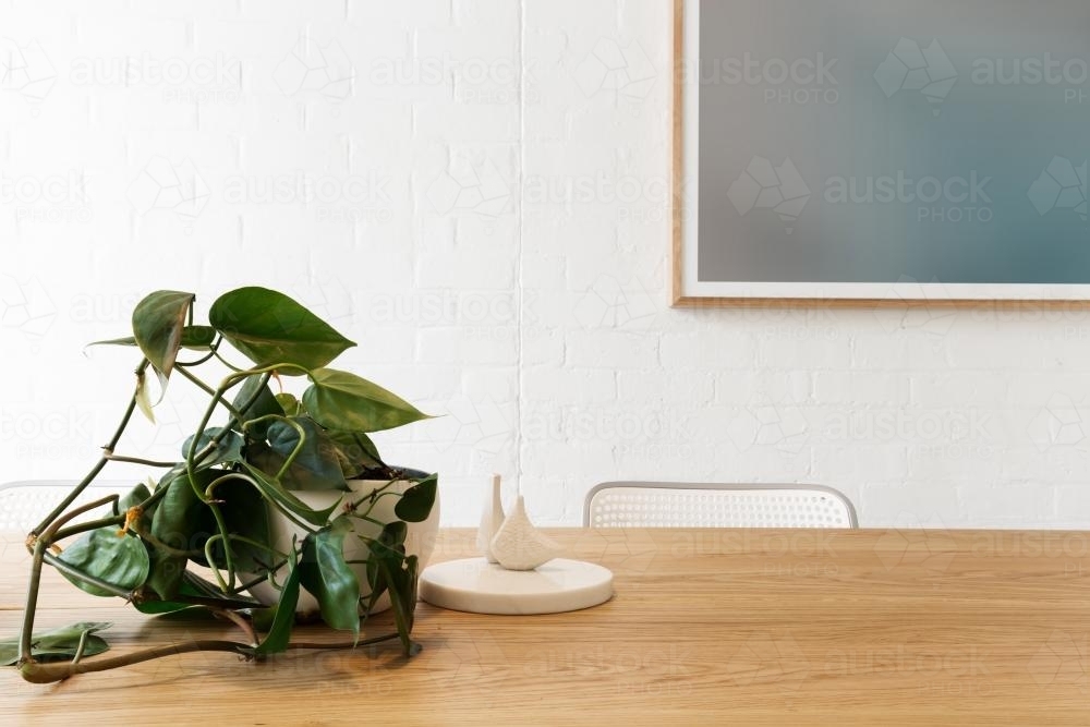 Danish styled interior objects with artwork on white brick wall in background with space for text - Australian Stock Image