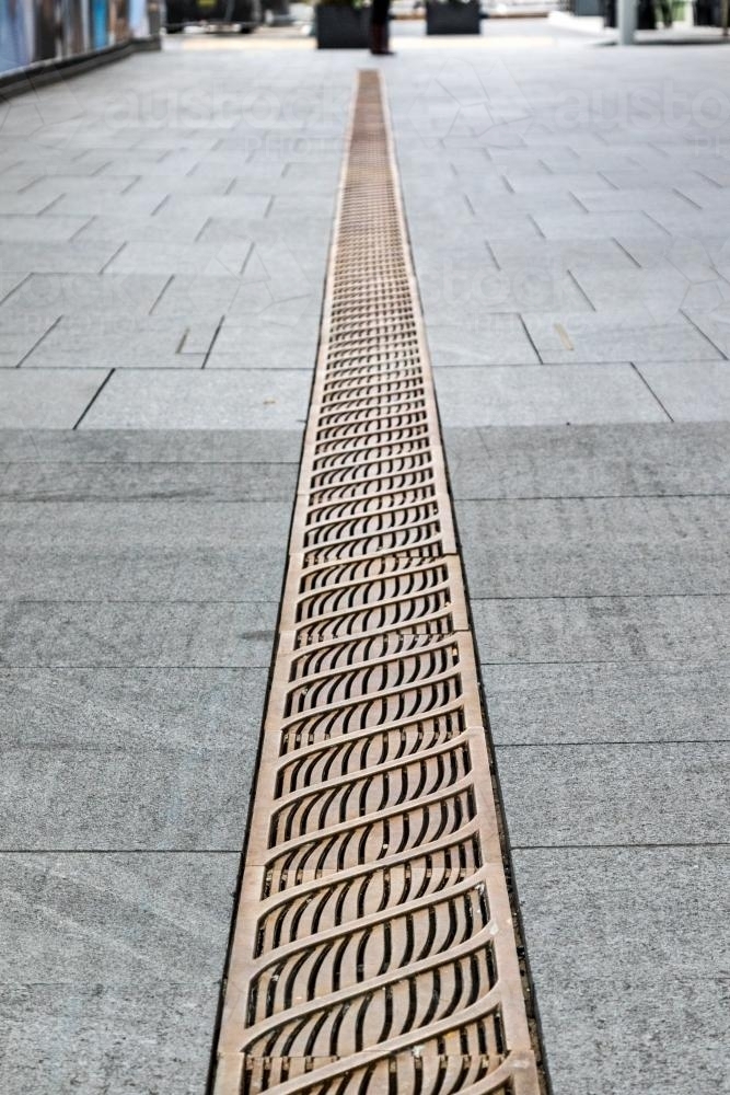 Darling Harbour street patterned water drain - Australian Stock Image