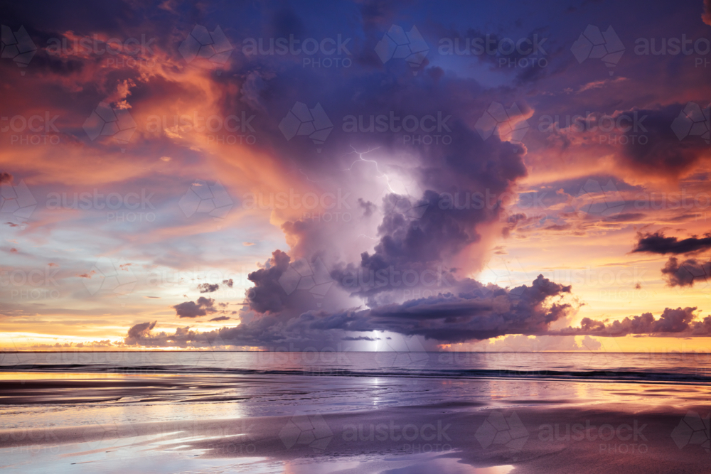 Darwin Sunset Lightning with dramatic anvil cloud over the beach - Australian Stock Image