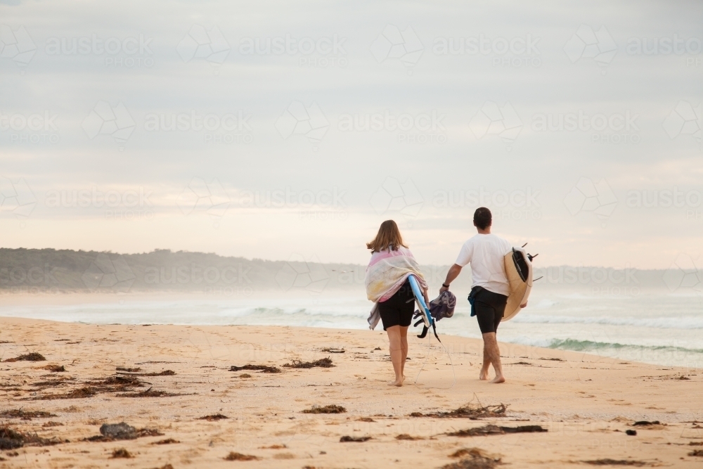 Daughter and father walking along beach together - Australian Stock Image