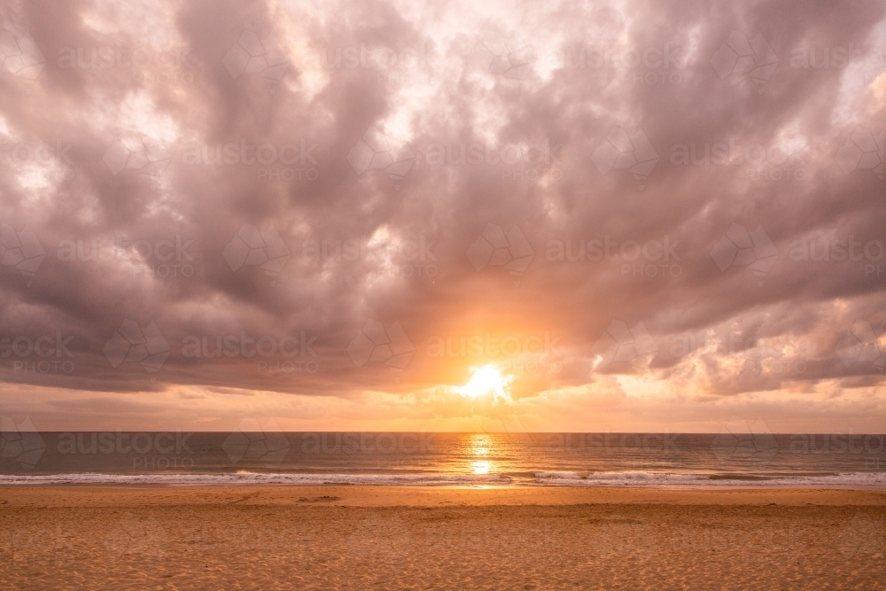 Dawn at the Beach with golden sunlight - Australian Stock Image