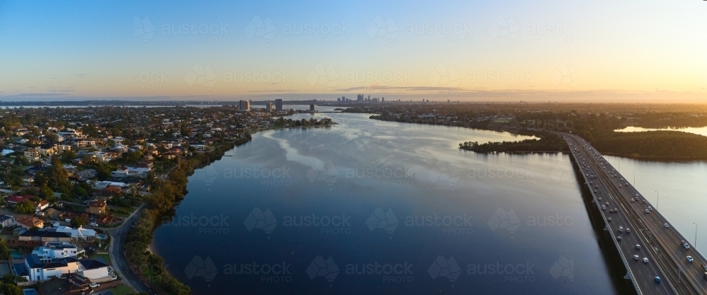 Dawn breaks over Perth's Canning River with the city skyline on the horizon - Australian Stock Image