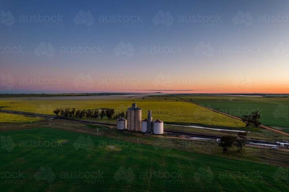 Dawn colours of the sky looking down on the silo storage. - Australian Stock Image
