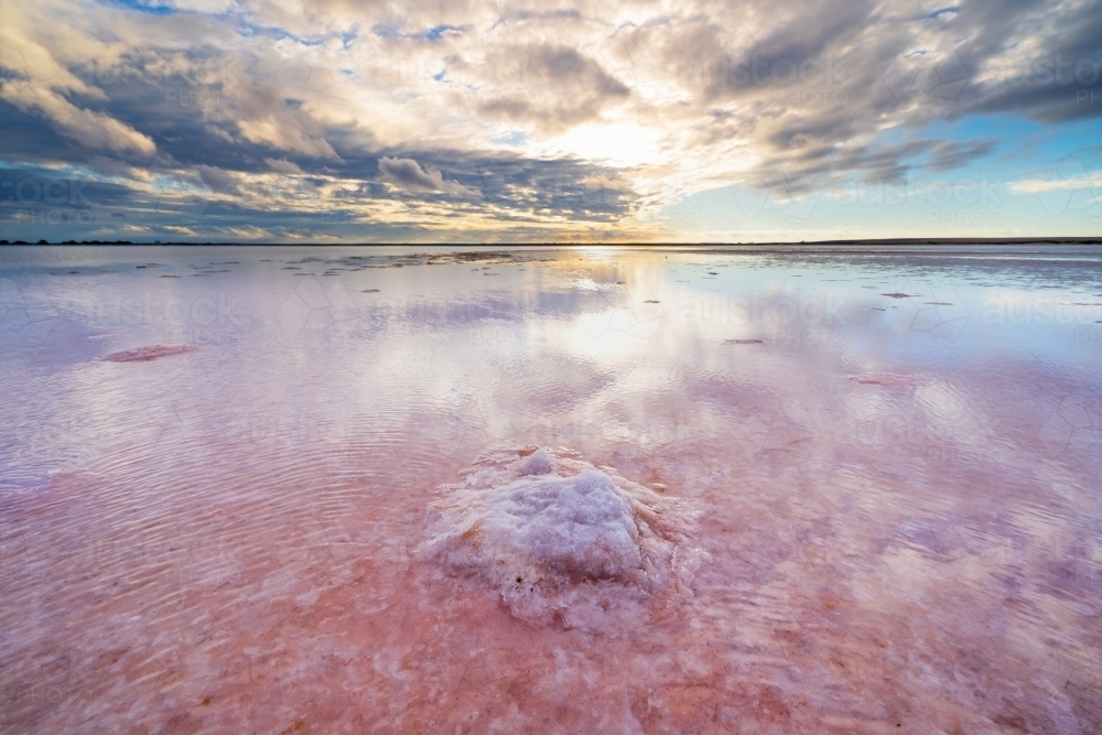 Dawn sky reflection in the still water a pink salt lake - Australian Stock Image