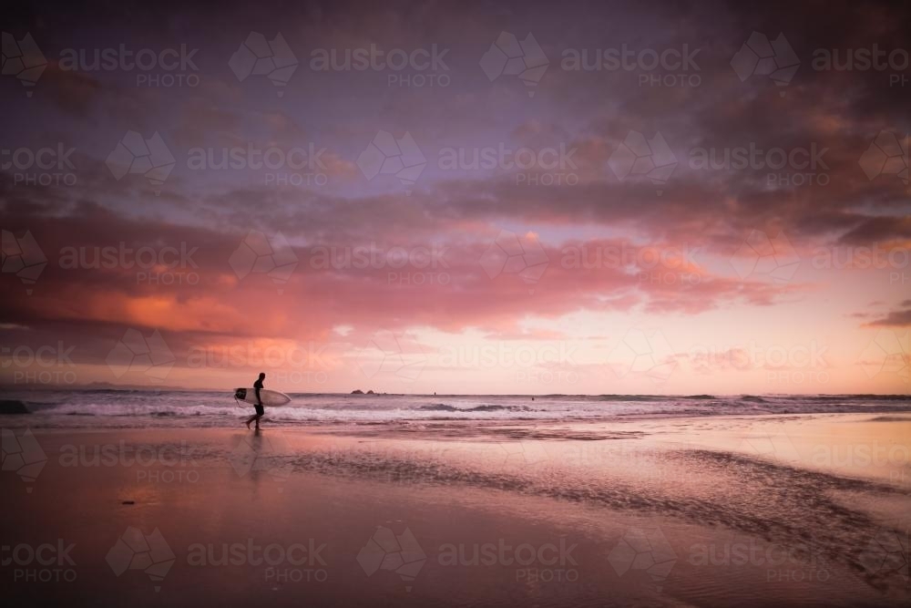 Dawn surfer at the beach Byron Bay (high iso) - Australian Stock Image