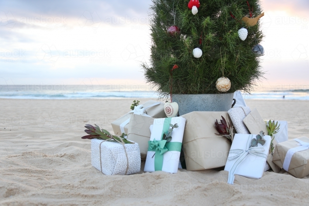 Decorated Christmas tree with presents and beach in background - Australian Stock Image