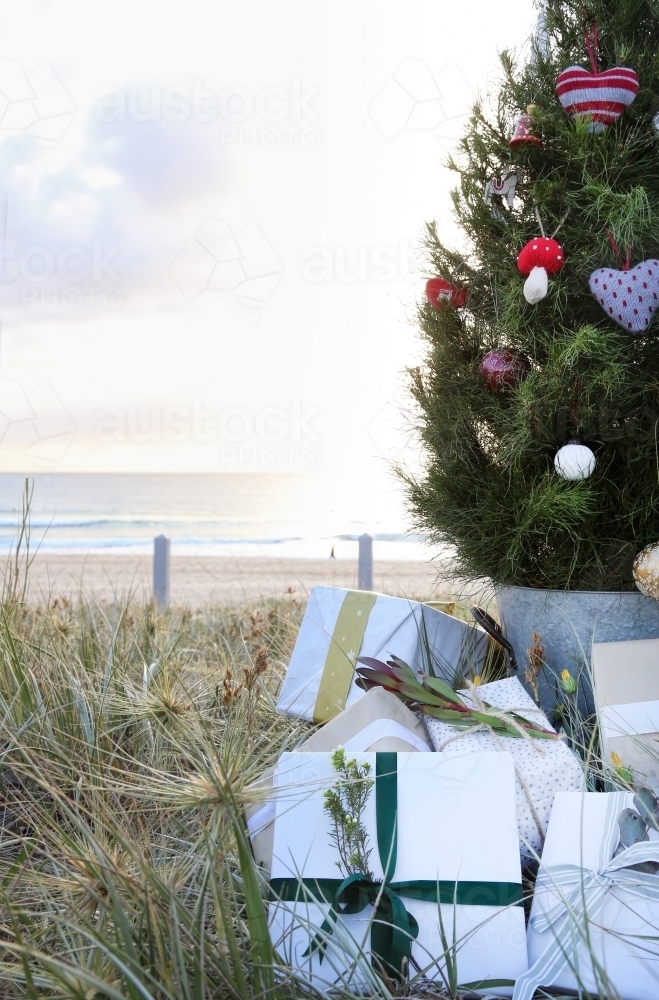 Decorated Christmas tree with presents and beach in background - Australian Stock Image