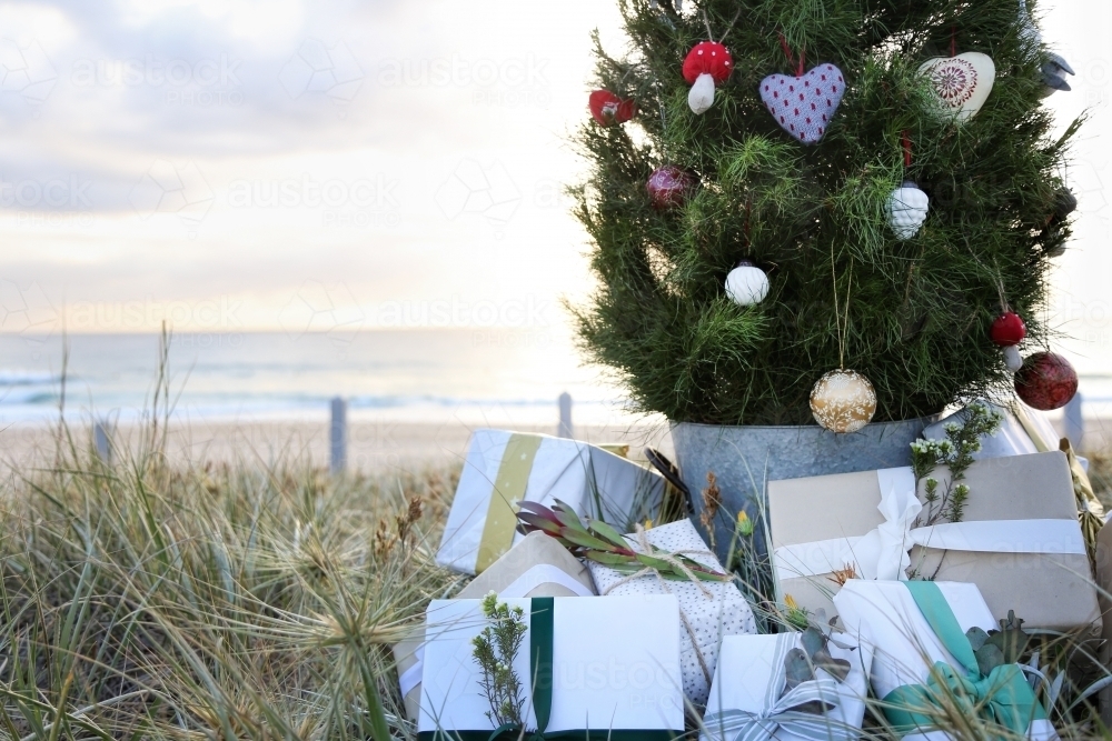 Decorated Christmas tree with presents at beach : Austockphoto Decorated Christmas tree with presents at beach - Australian Stock Image