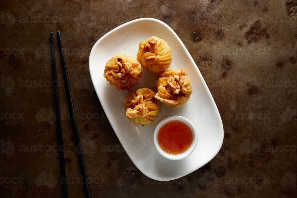 Deep fried dumpling dish on table - Australian Stock Image