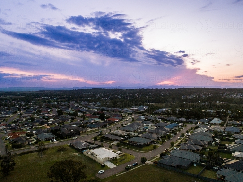 Deep purple sunset sky over houses of Singleton in NSW Australia - Australian Stock Image