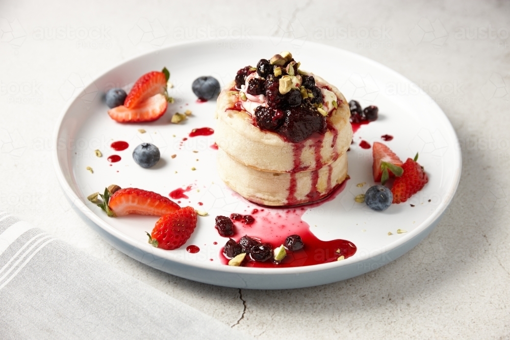 Delicious crumpets with berries and ice cream - Australian Stock Image
