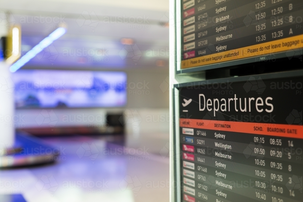Departure sign showing flights at an airport - Australian Stock Image