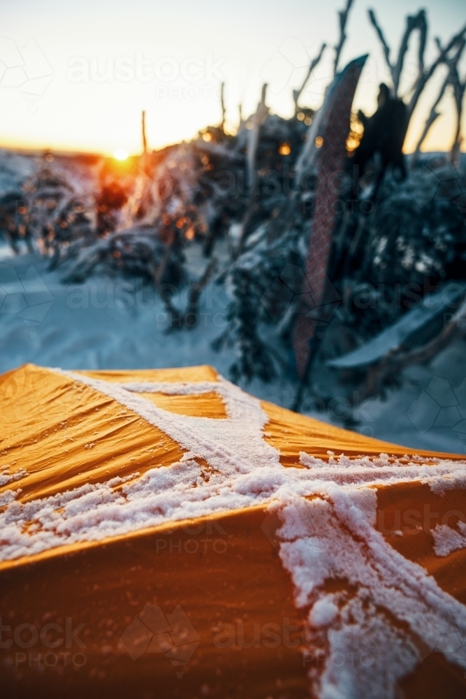 Depth of field view over tent looking at sunrise - Australian Stock Image