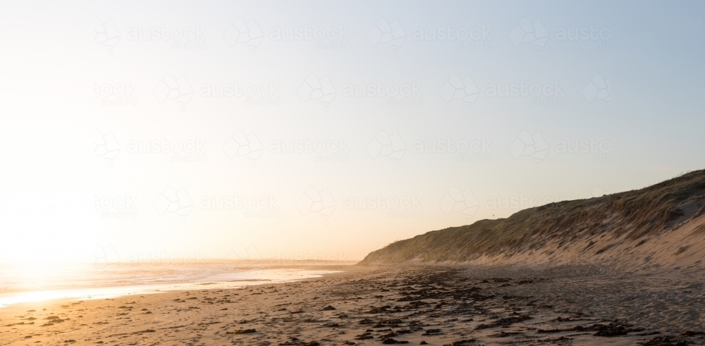 Deserted beach at sunrise - Australian Stock Image