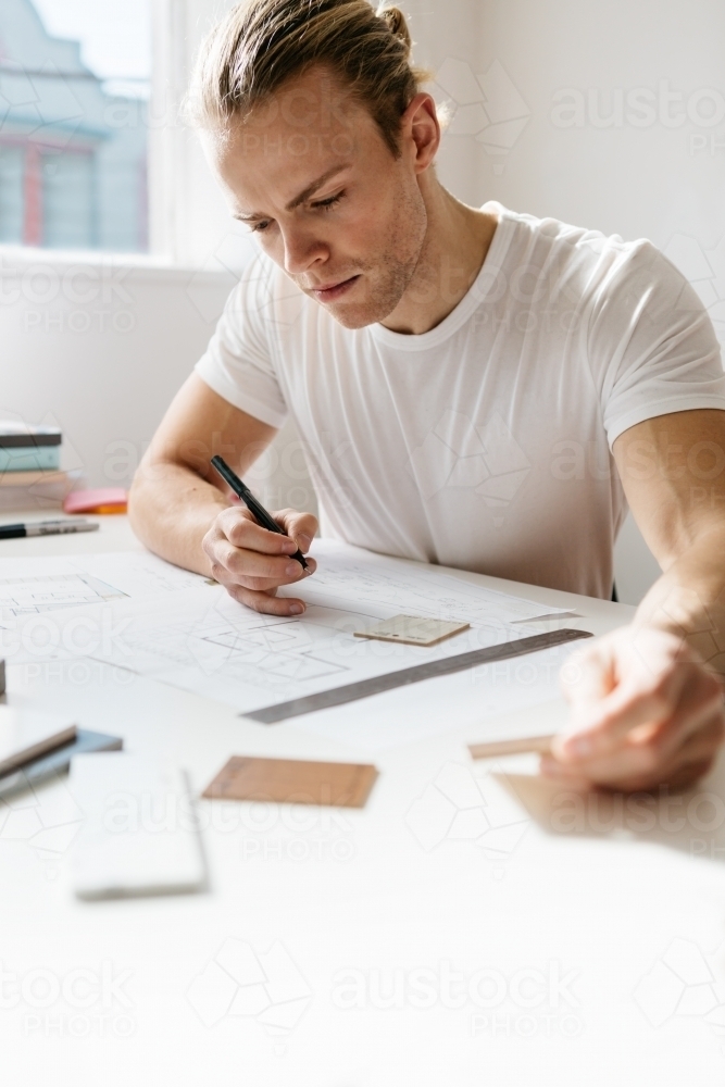 Designer choosing finishes for a home with space for text - Australian Stock Image
