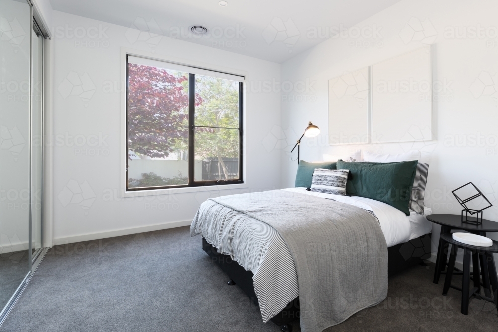 Designer styled bedroom with garden outlook - Australian Stock Image