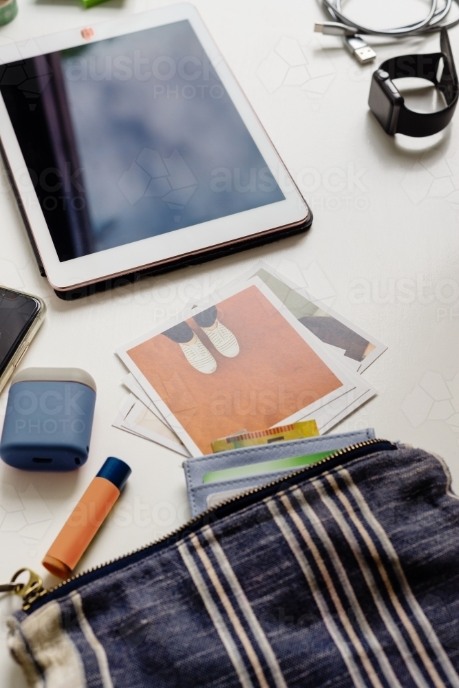 desktop with ipad, polaroids and purse - Australian Stock Image