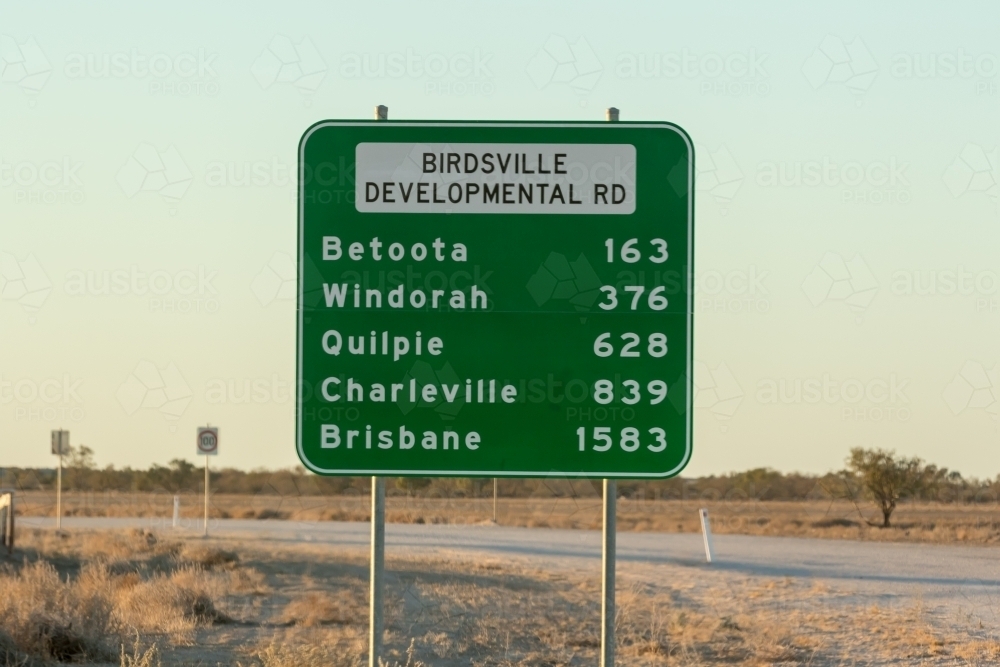 Destination green road sign against rural background - Australian Stock Image