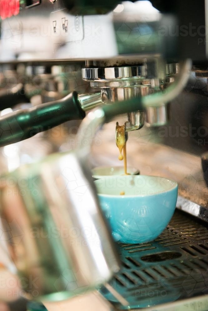 Detail of a commercial coffee machine making coffee inside a cafe - Australian Stock Image