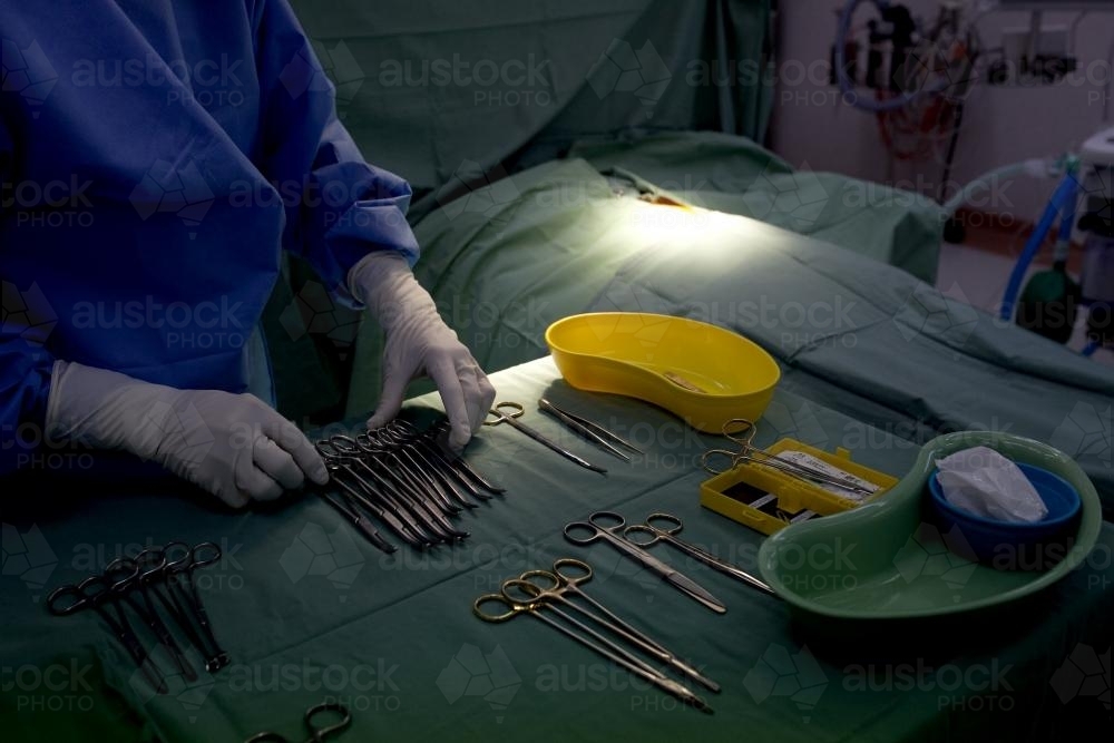Detail of a nurse preparing equipment for surgery in a hospital operating theatre - Australian Stock Image