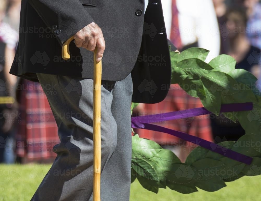 Detail of elderly male digger laying a wreath on ANZAC Day - Australian Stock Image