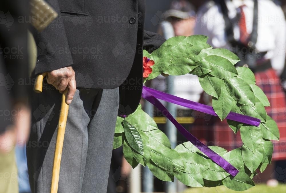 Detail of elderly male digger laying a wreath on ANZAC Day - Australian Stock Image