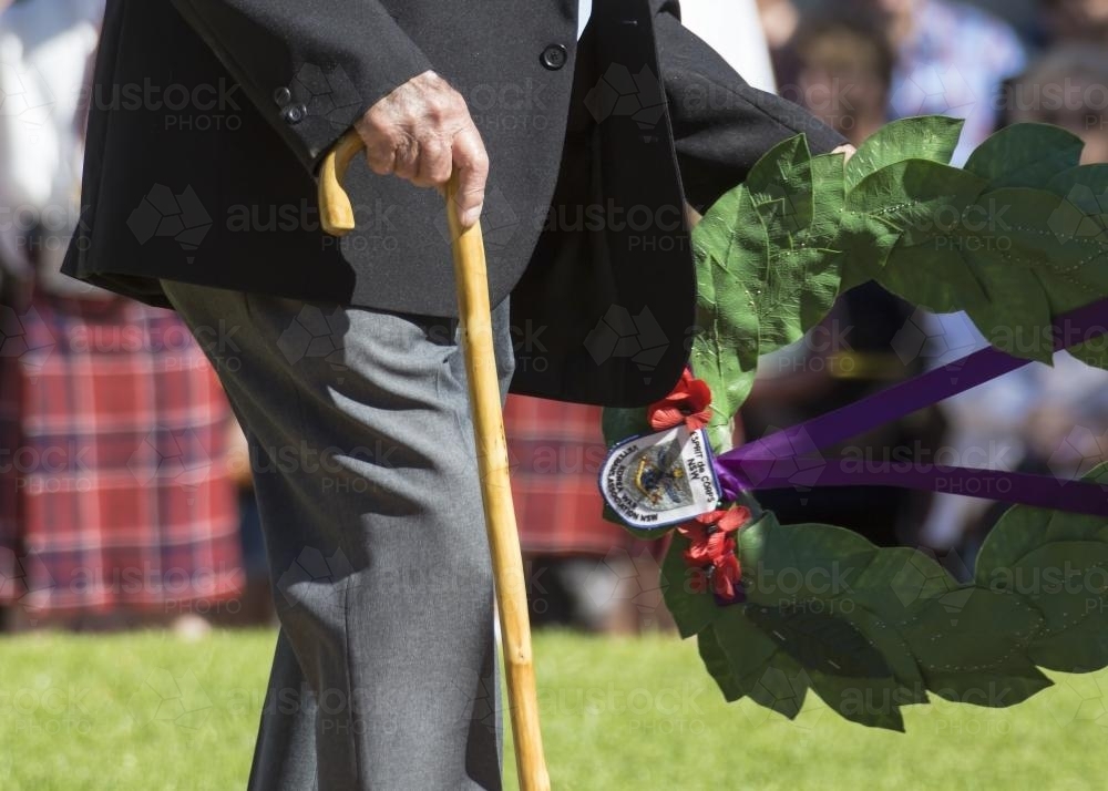 Detail of elderly male digger laying a wreath on ANZAC Day - Australian Stock Image