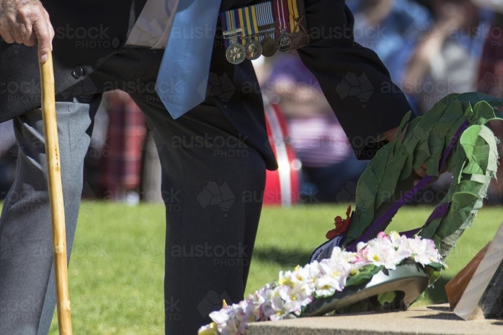 Detail of elderly male digger laying a wreath on ANZAC Day - Australian Stock Image