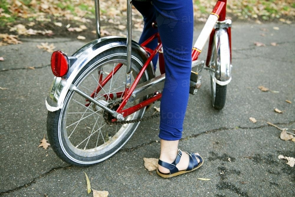 Detail of girl wearing sandals riding bike - Australian Stock Image