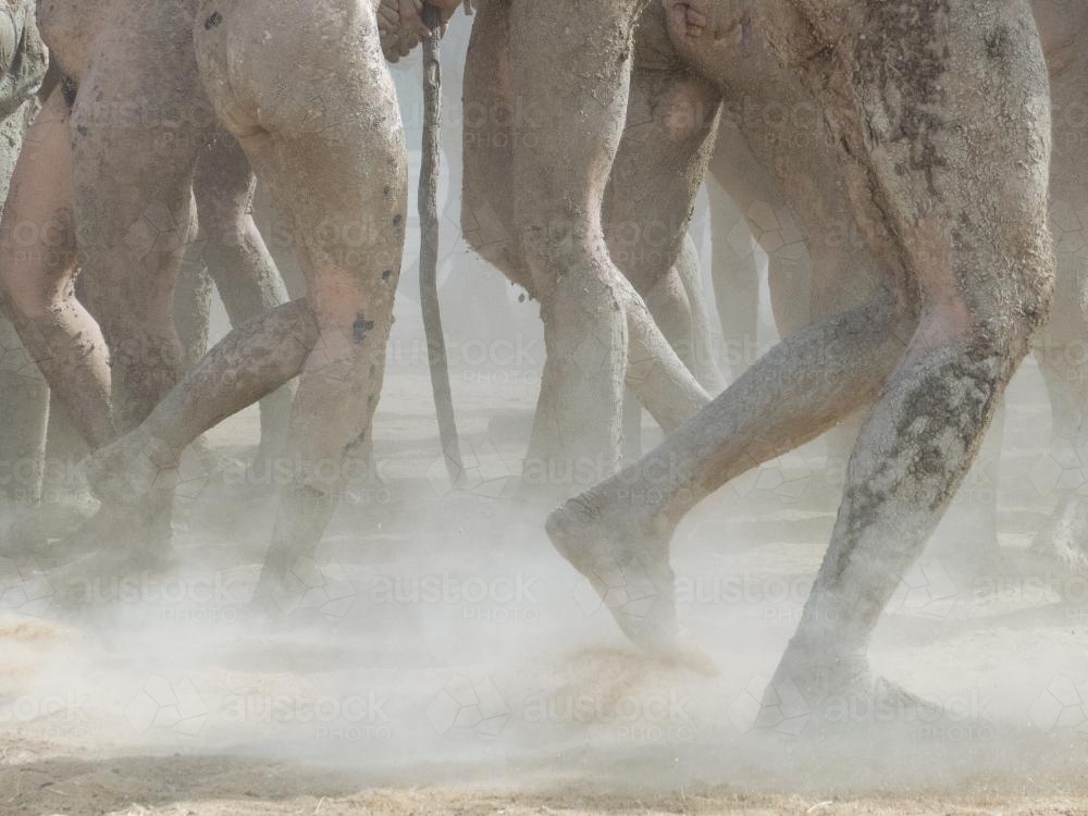 Detail of group of muddy legs dancing at a festival - Australian Stock Image
