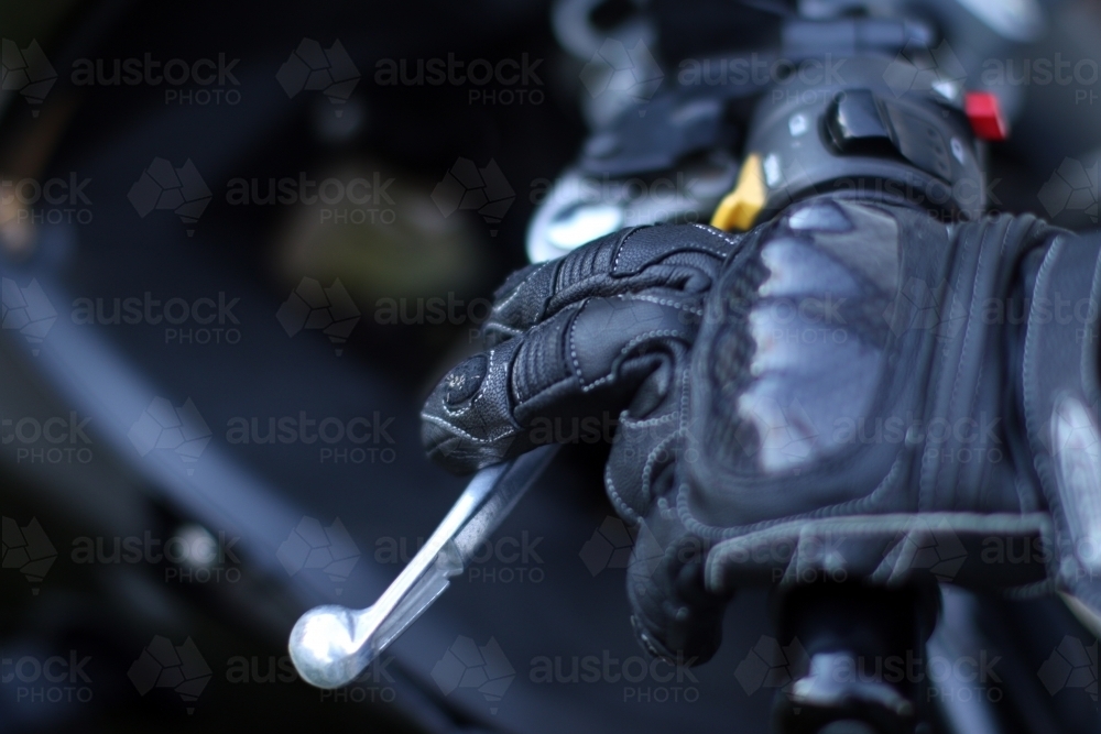 Detail of motorbike glove holding handlebar - Australian Stock Image