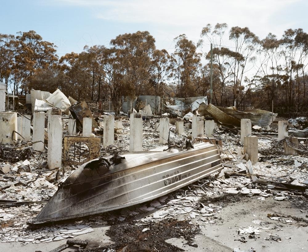 Detail of remains of a house destroyed by fire with boat - Australian Stock Image
