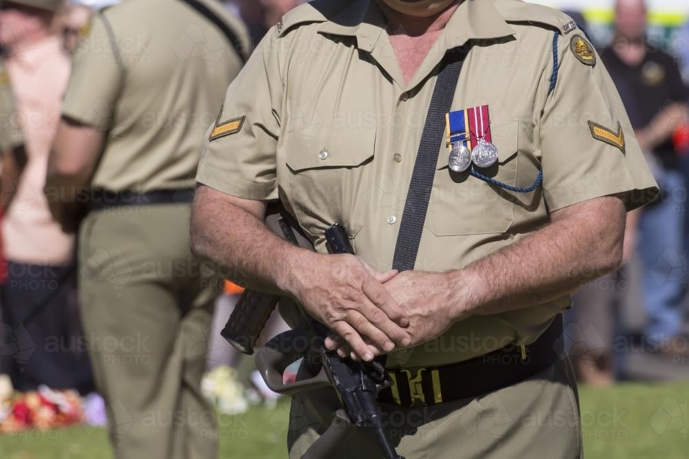 Detail of soldier in uniform with rifle during ANZAC Day Ceremony - Australian Stock Image